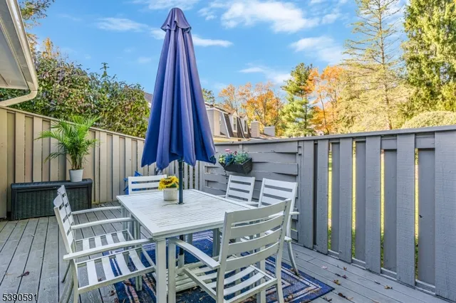 a view of balcony with wooden floor and outdoor seating