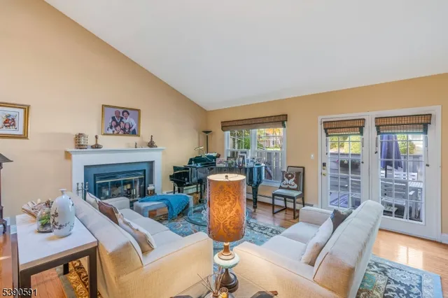 a living room with furniture a fireplace and a table