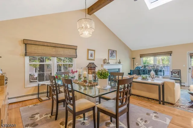 a dining room with furniture a chandelier and wooden floor