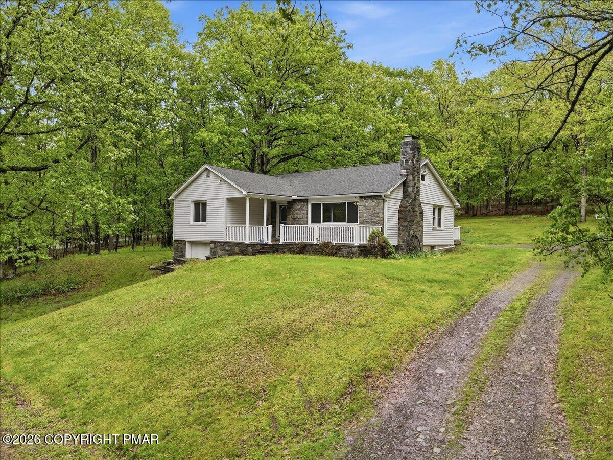 232 Garrity Road Hawley, PA 18428 - Photo 7 of 57 a front view of a house with garden