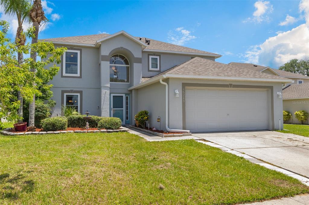 16243 Wilkinson Drive Clermont, FL 34714 - Photo 1 of 1 a front view of a house with a yard and garage