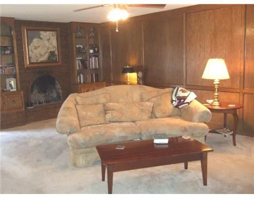 a living room with furniture and a lamp