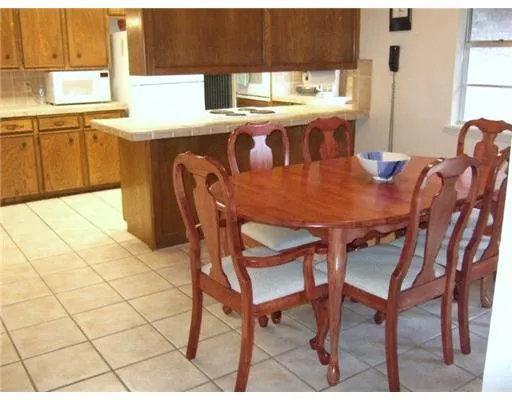 a dining room with furniture a window and kitchen view