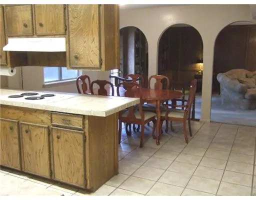 a close view of dining table chairs and a sink