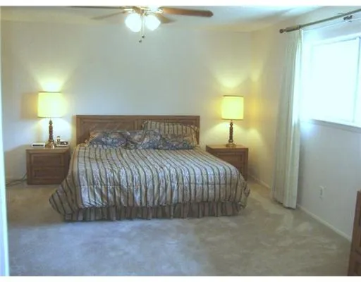 a bedroom with a bed and a lamp