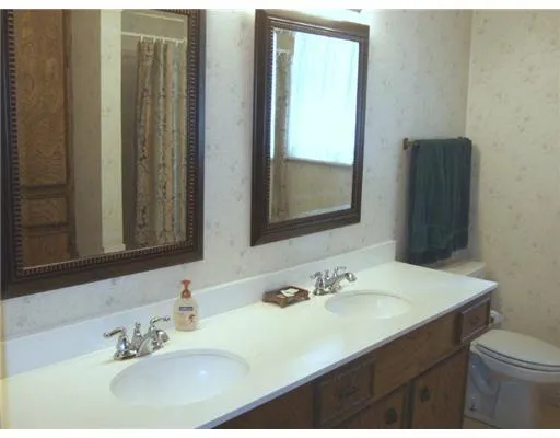 a bathroom with a sink vanity mirror and toilet