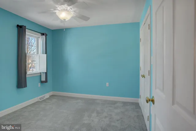 a view of an empty room with a bathroom