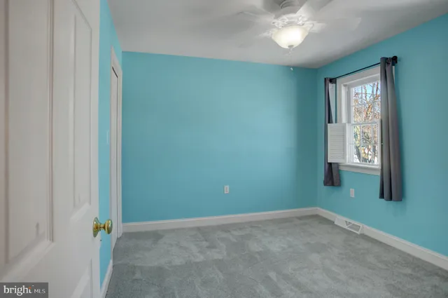 an empty room with closet and a bathroom