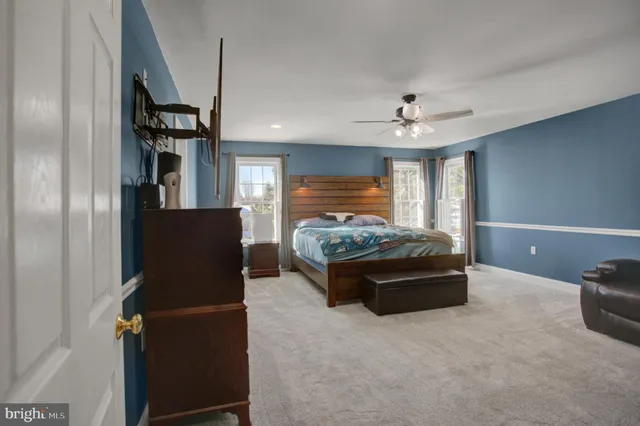 a bedroom with a bed and a television