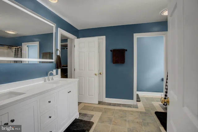a bathroom with a bathtub a shower and a window