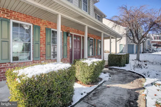 a view of a house with a large window and yard