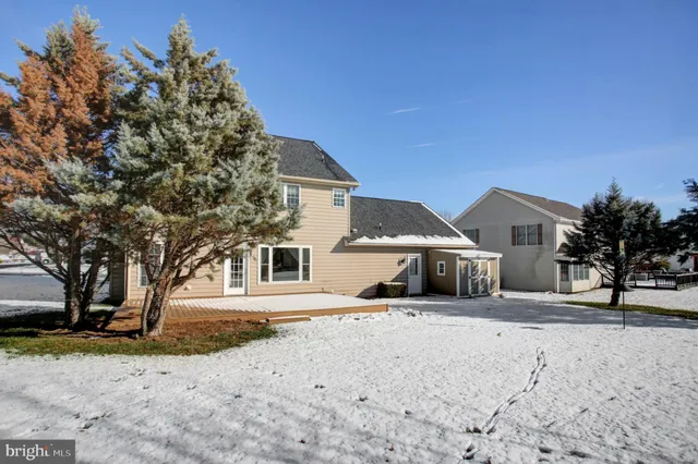 a view of a yard with snow on the road