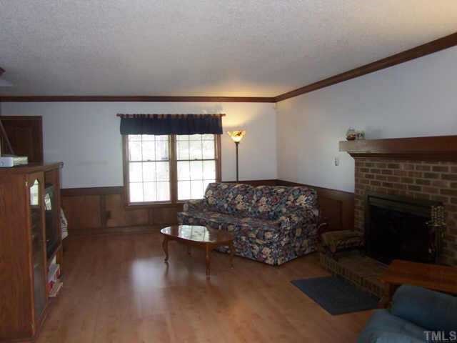 5321 Ridgeloch Place Raleigh, NC 27612 - Photo 4 of 10 a living room with furniture and a fireplace