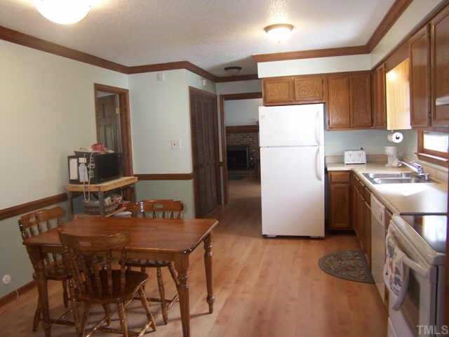 5321 Ridgeloch Place Raleigh, NC 27612 - Photo 7 of 10 a kitchen with refrigerator and chairs