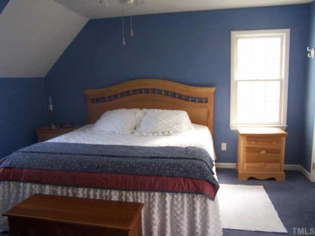 5321 Ridgeloch Place Raleigh, NC 27612 - Photo 9 of 10 a bedroom with a bed and window