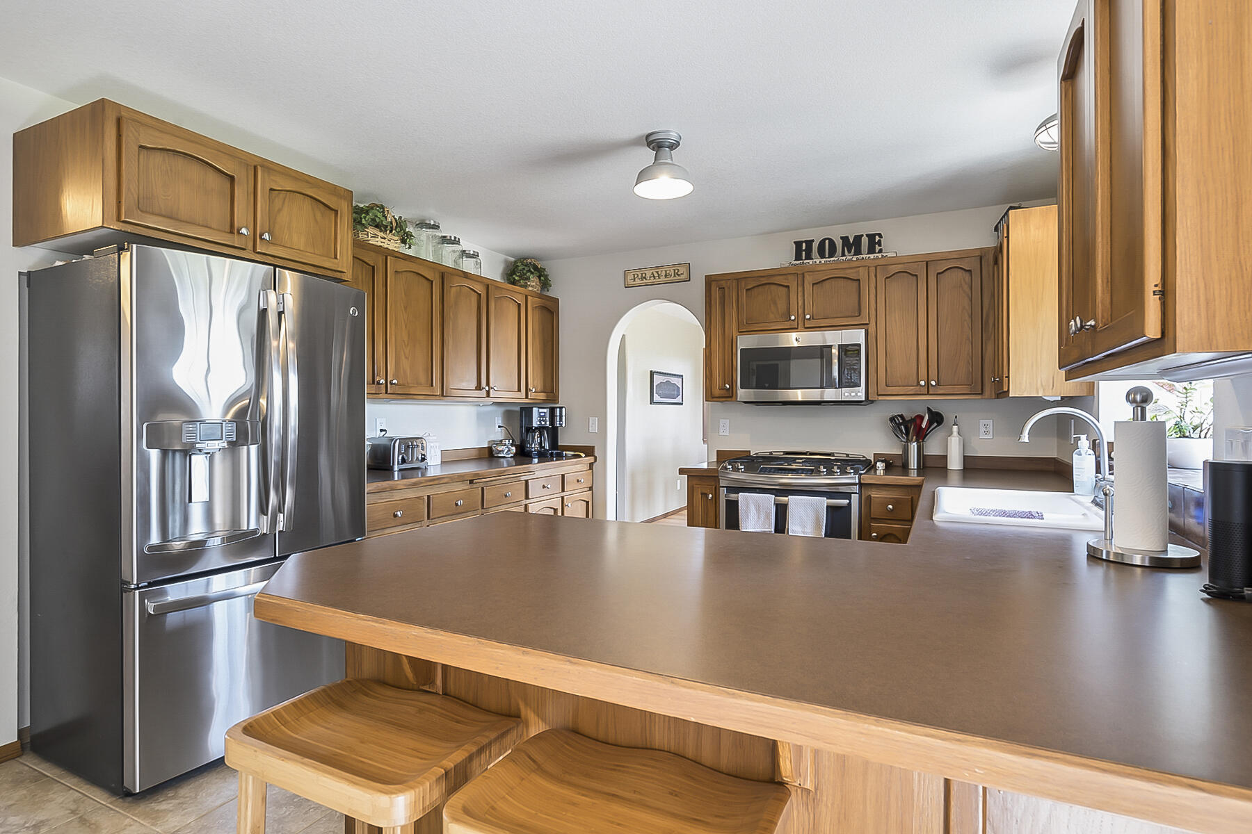 61030 Jennings Road Bend, OR 97702 - Photo 20 of 76 a kitchen with stainless steel appliances granite countertop a refrigerator a stove top oven a sink and dishwasher