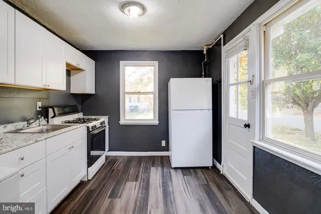 a kitchen with a refrigerator and a sink