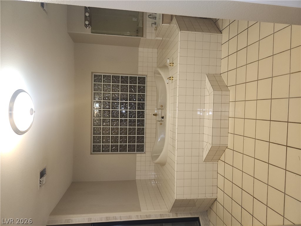 564 Ridgeway Road Henderson, NV 89015 - Photo 12 of 22 Indulge in a tranquil bathing experience with this deep soaking tub and classic tiled surround.