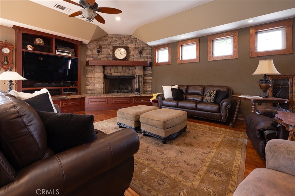 6071 Sun View Road Yorba Linda, CA 92886 - Photo 11 of 49 a living room with furniture a flat screen tv and a fireplace