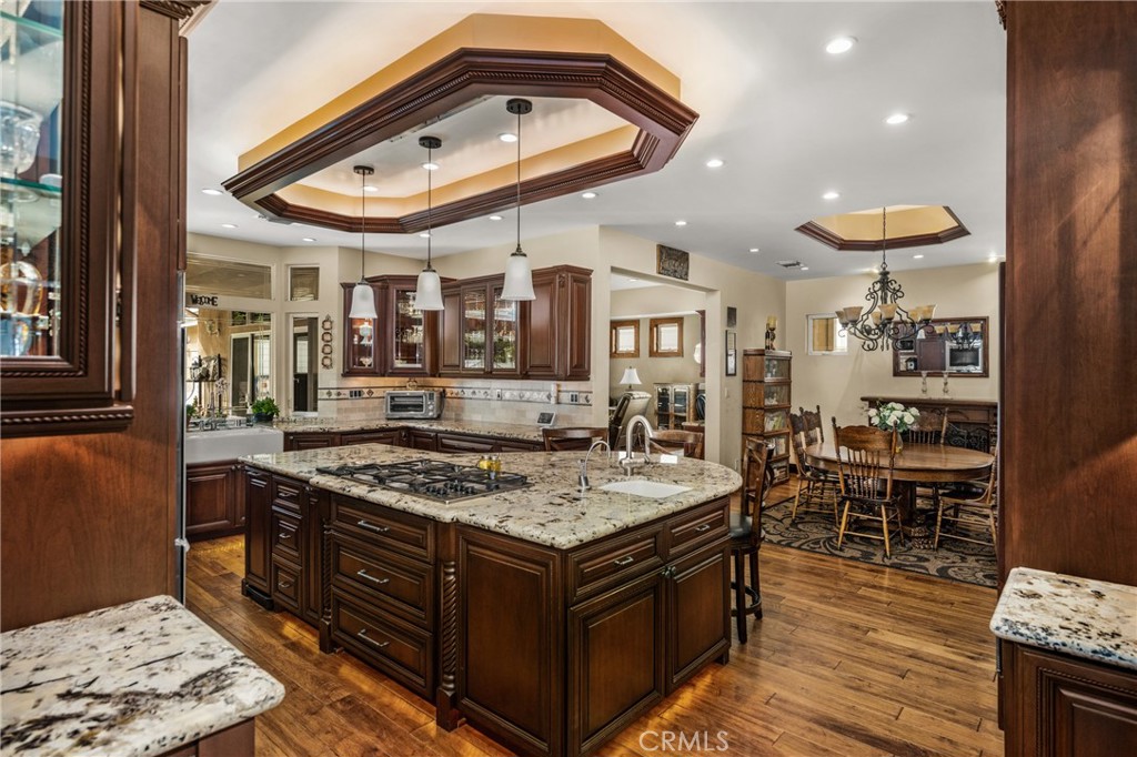 6071 Sun View Road Yorba Linda, CA 92886 - Photo 14 of 65 Oversized island has beaded cherry cabinets and Splendor granite and hosts a vegetable sink, gas 5 burner Dacor cooktop and seating for 3