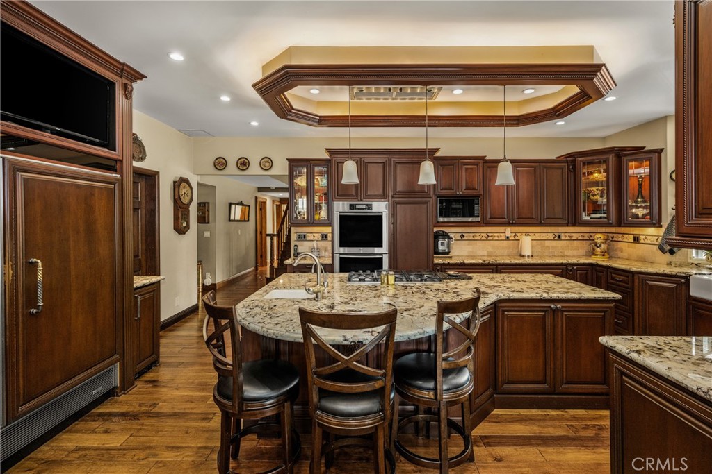 6071 Sun View Road Yorba Linda, CA 92886 - Photo 15 of 65 Recessed, in and under cabinet lighting and kickplate lighting, Miele double oven with warming drawer, Kitchenaide dishwasher with panel doors, deep drawers and pull out cabinets