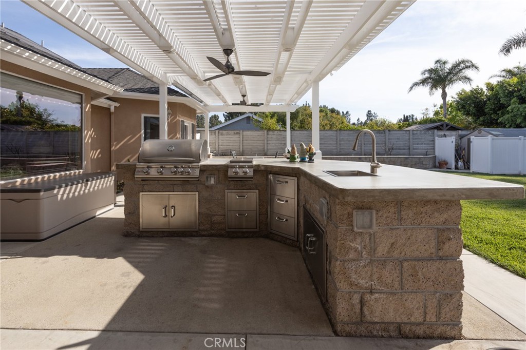 6071 Sun View Road Yorba Linda, CA 92886 - Photo 16 of 49 a utility room with stainless steel appliances kitchen island granite countertop a sink and cabinets
