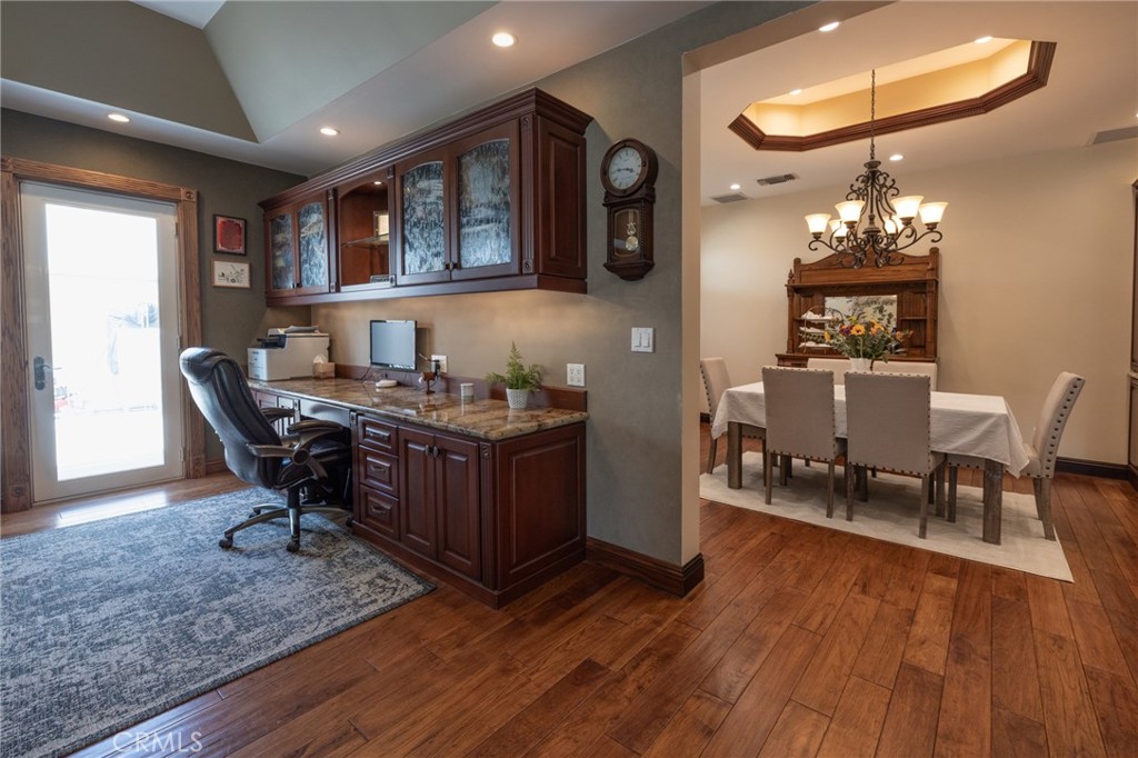 6071 Sun View Road Yorba Linda, CA 92886 - Photo 10 of 49 a dining room with wooden floor a chandelier a wooden table and chairs