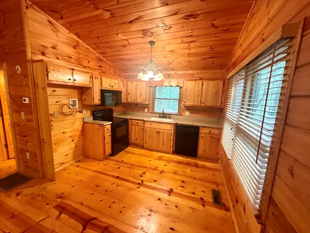 a kitchen with stainless steel appliances granite countertop a sink and cabinets