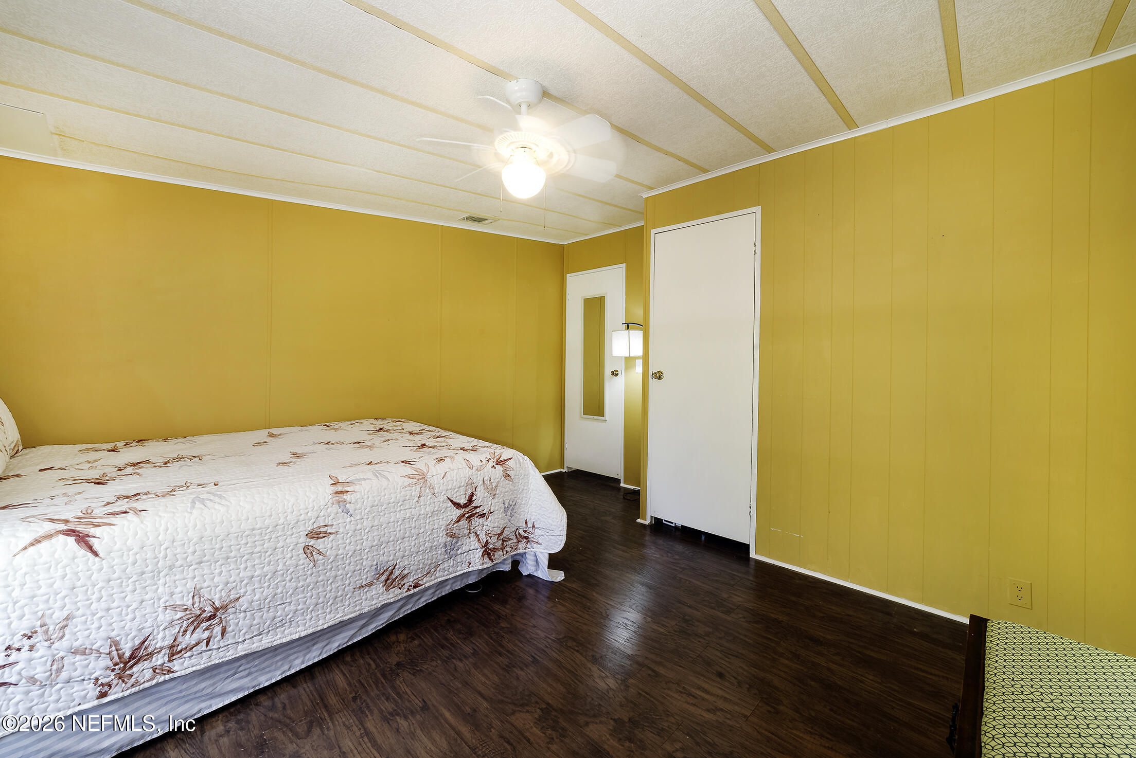 206 Dolphin Drive Georgetown, FL 32139 - Photo 12 of 27 a bedroom with a bed and wooden floor