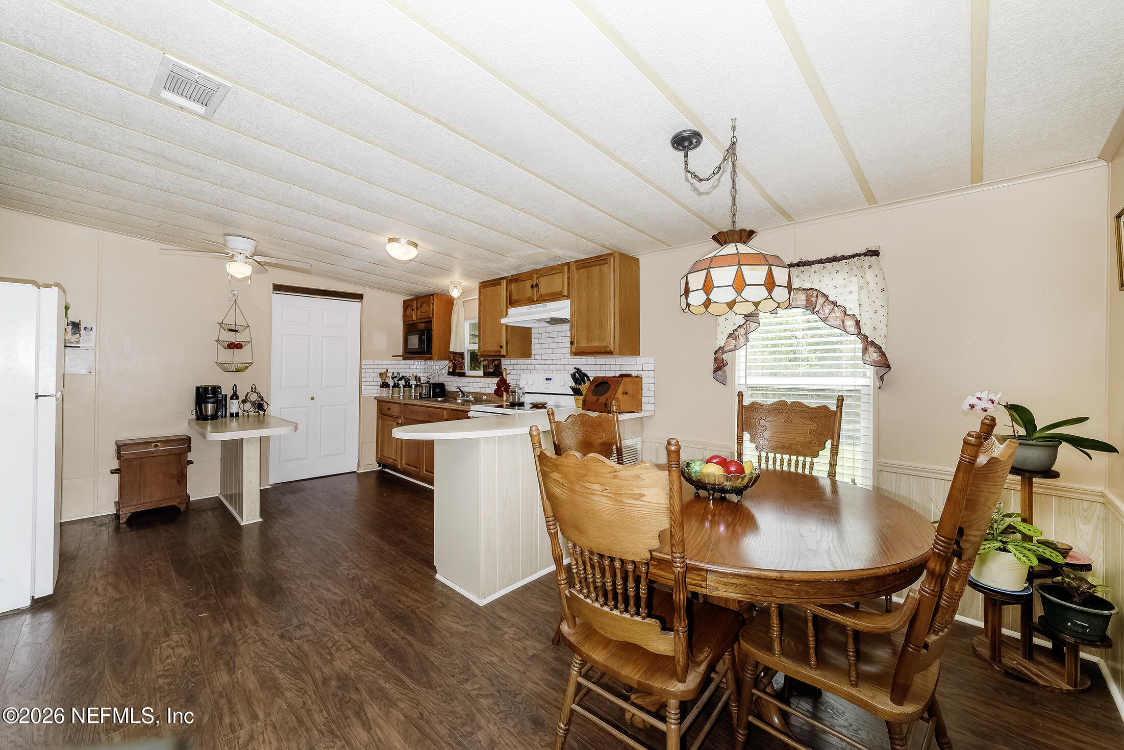 206 Dolphin Drive Georgetown, FL 32139 - Photo 13 of 27 a view of a dining room with furniture and wooden floor