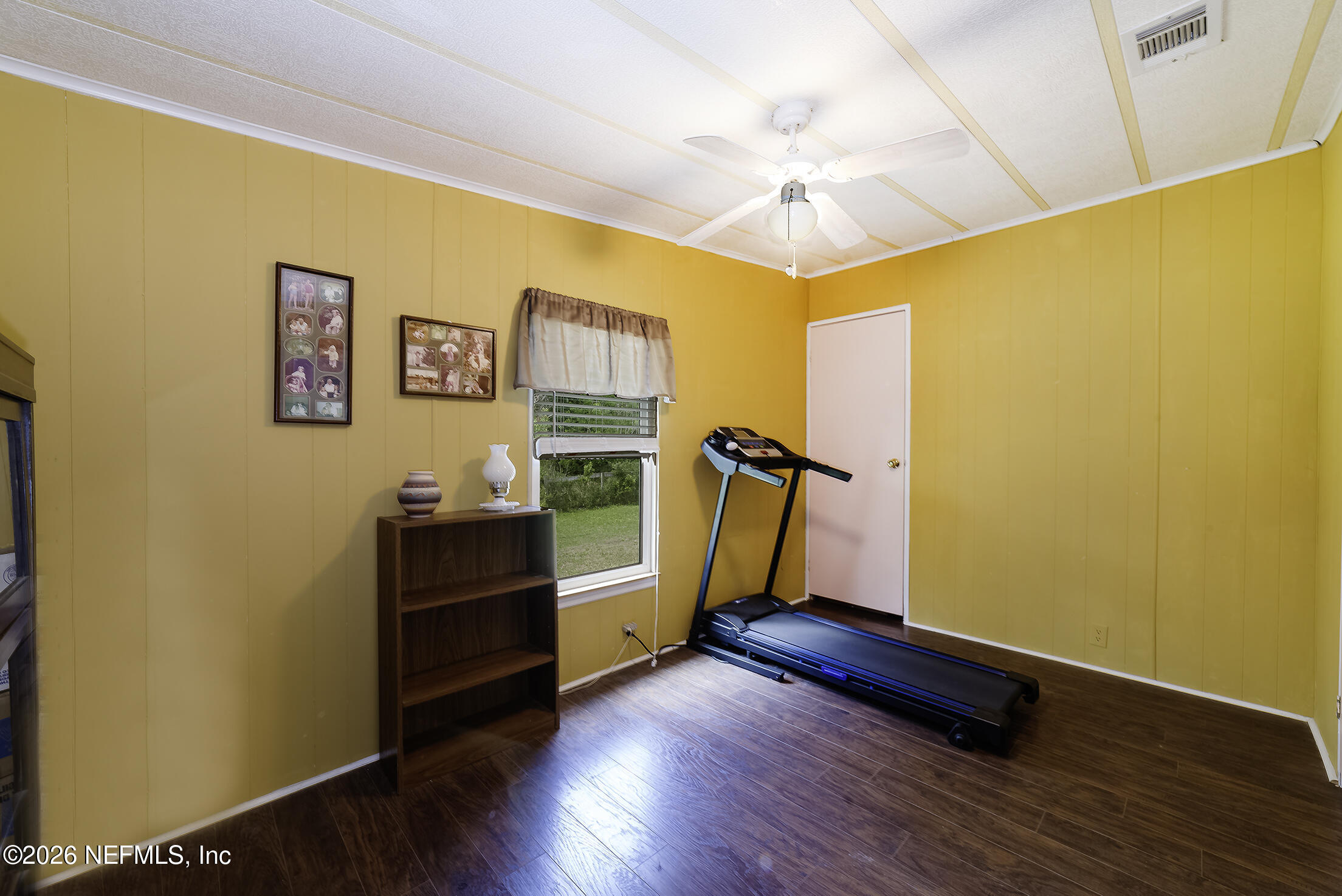 206 Dolphin Drive Georgetown, FL 32139 - Photo 10 of 27 a view of a room with wooden floor and ceiling fan