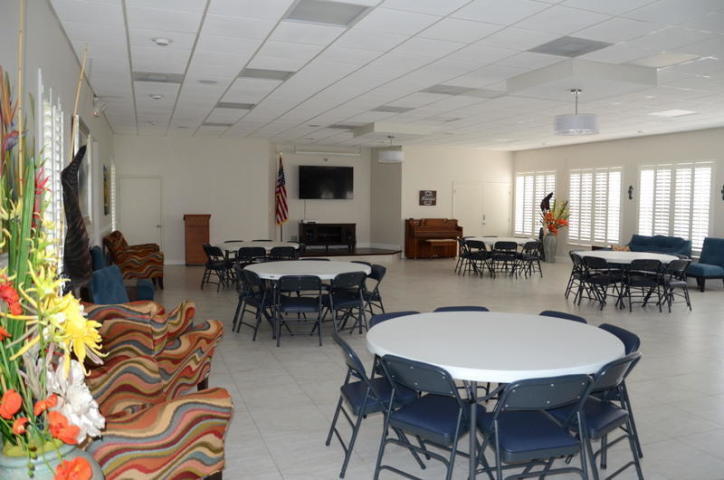 2600 Southwest 22nd Avenue, Unit 903 Delray Beach, FL 33445 - Photo 17 of 27 a view of a dining room with furniture window and wooden floor