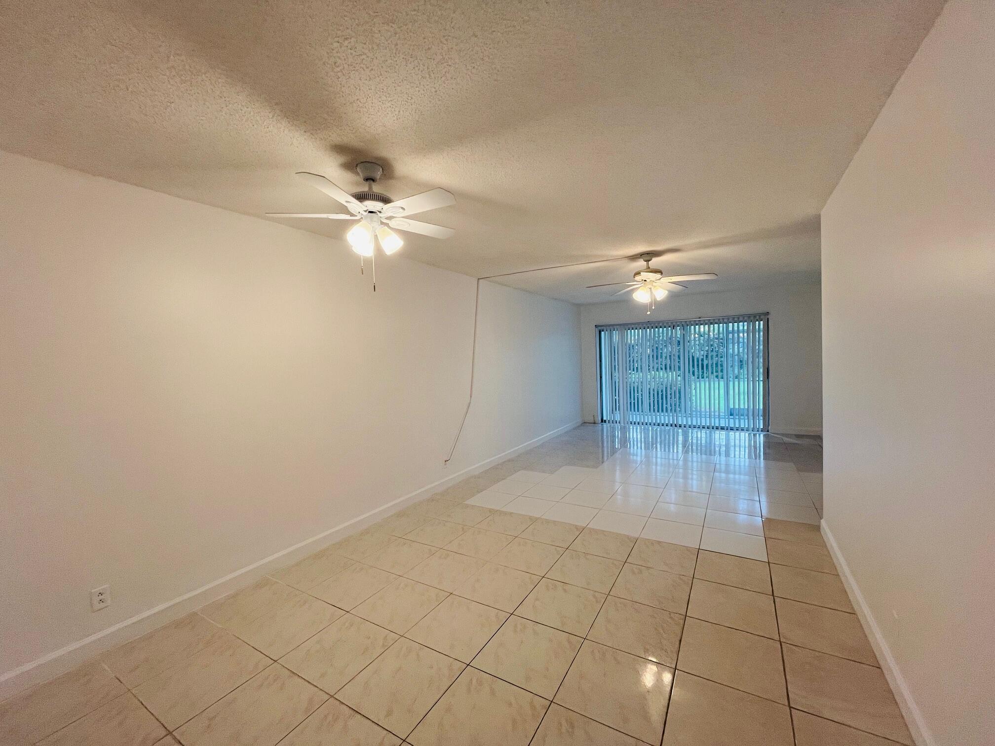 2600 Southwest 22nd Avenue, Unit 903 Delray Beach, FL 33445 - Photo 2 of 27 wooden floor in an empty room with a window