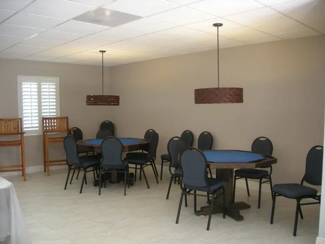 a view of a dining room and livingroom furniture wooden floor a chandelier