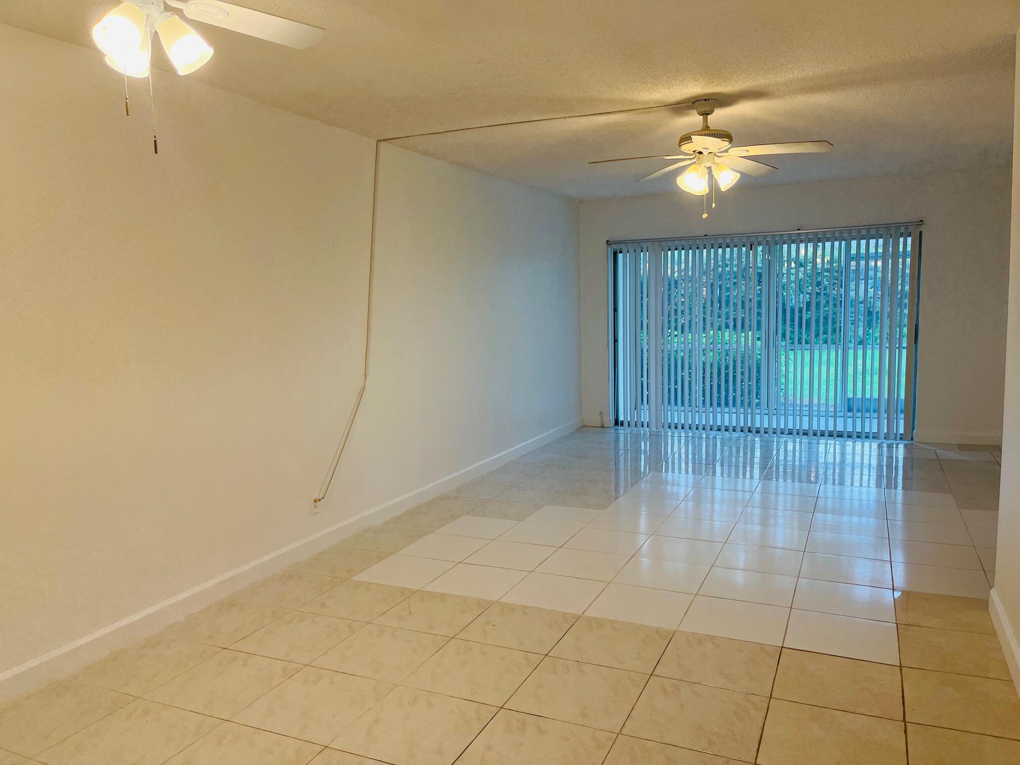 2600 Southwest 22nd Avenue, Unit 903 Delray Beach, FL 33445 - Photo 3 of 27 a view of an empty room with a chandelier fan