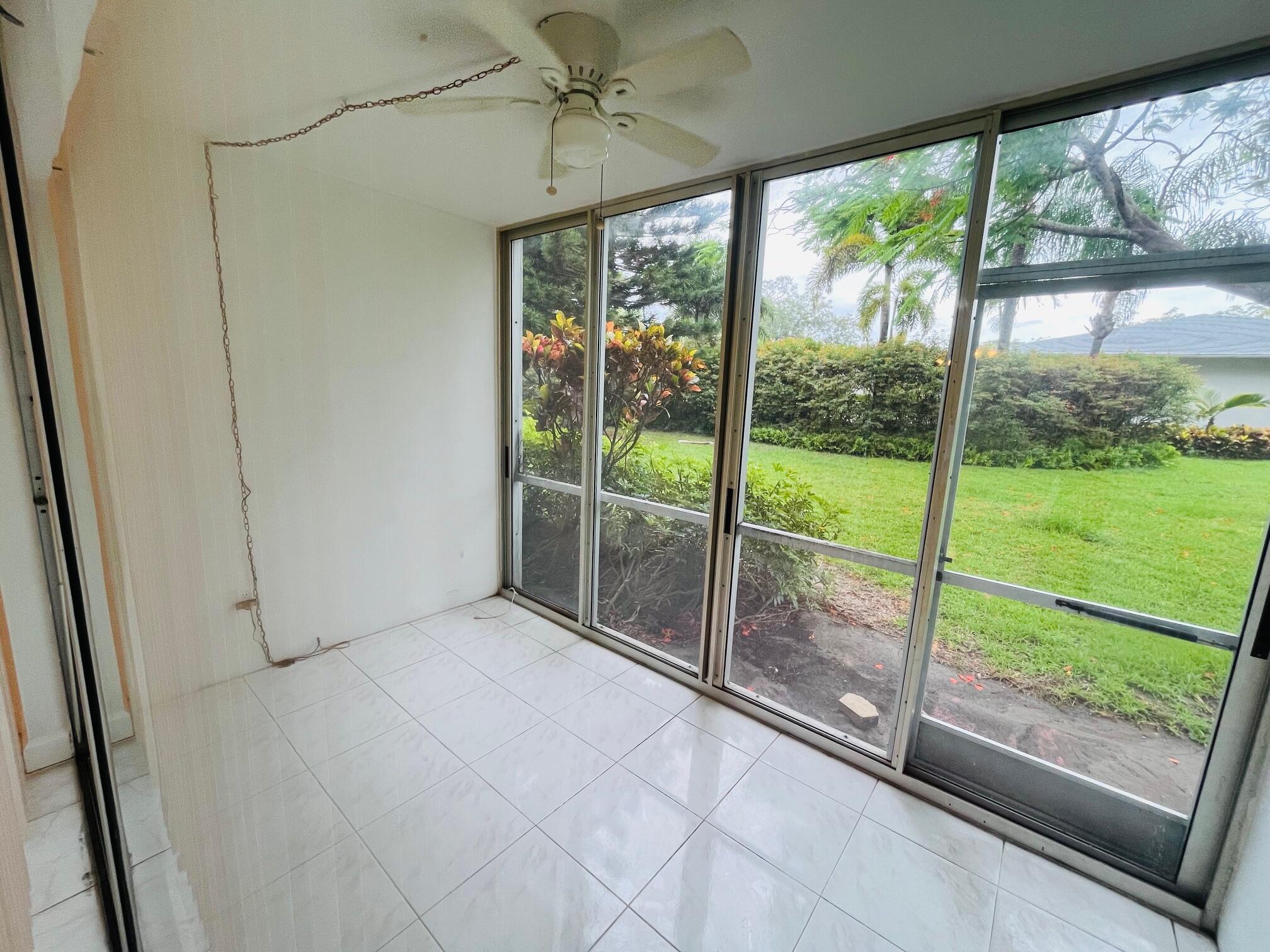 2600 Southwest 22nd Avenue, Unit 903 Delray Beach, FL 33445 - Photo 5 of 27 a view of an empty room and windows