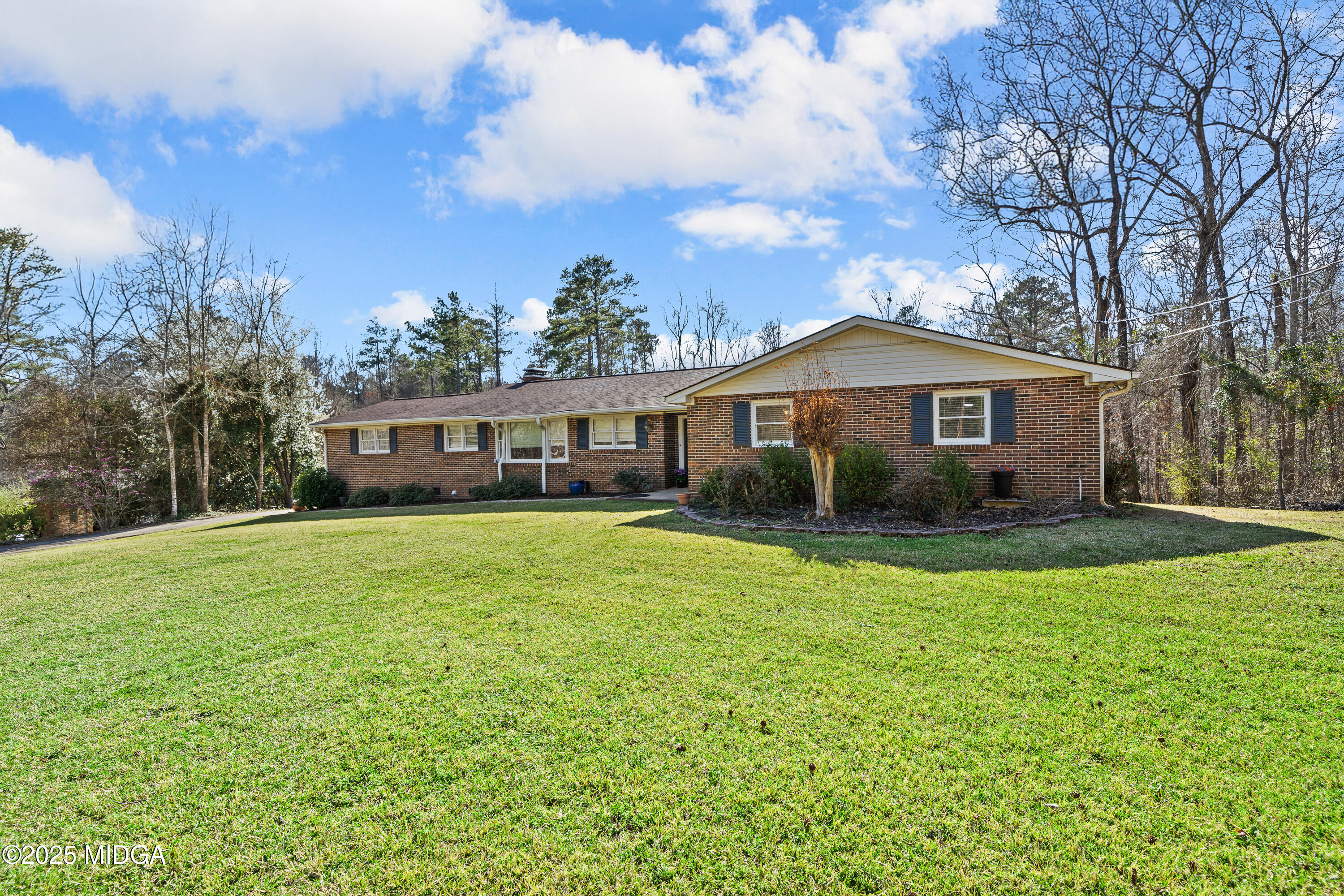 184 Camelot Road Gray, GA 31032 - Photo 2 of 38 a front view of a house with a garden