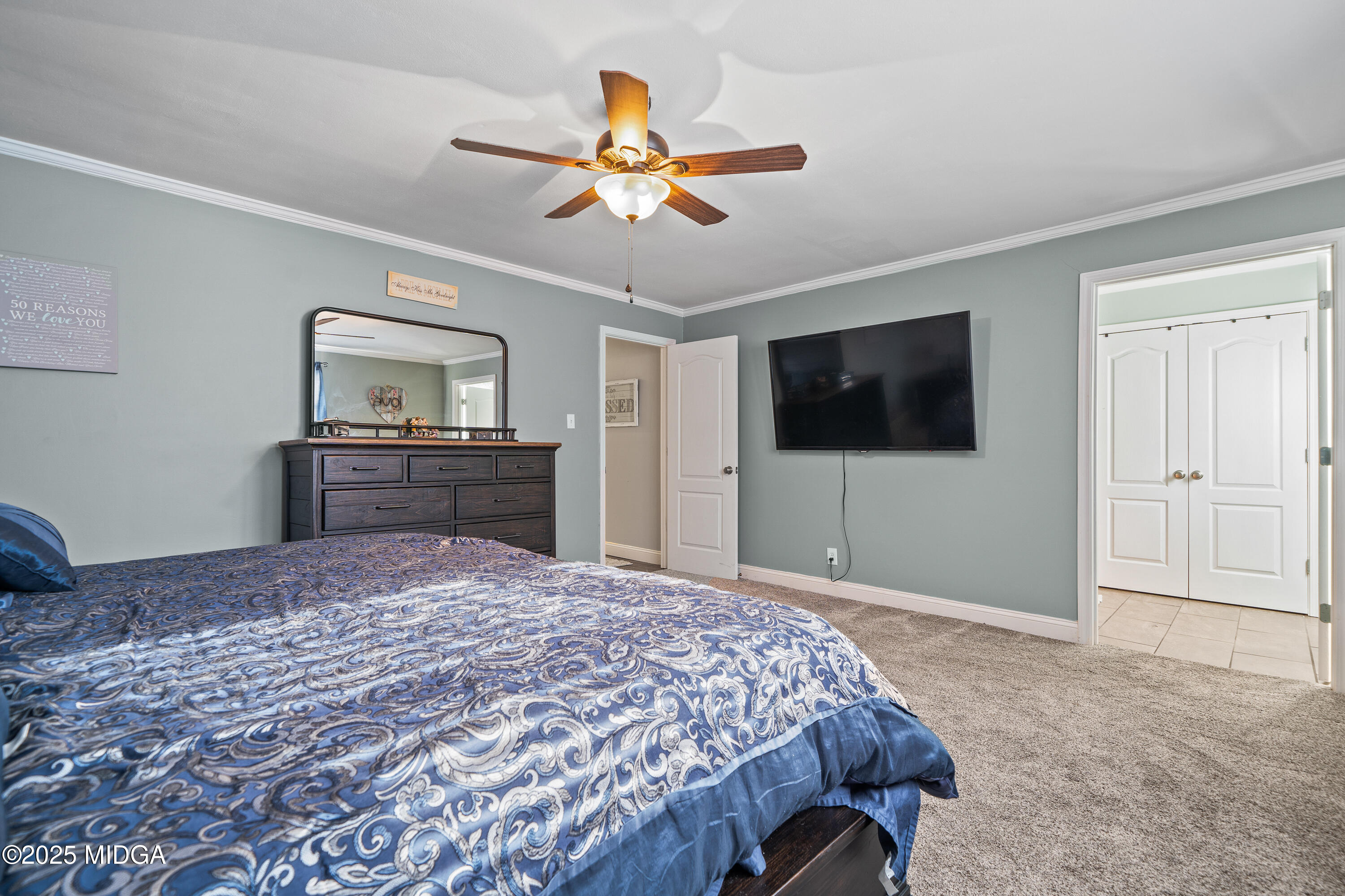 184 Camelot Road Gray, GA 31032 - Photo 31 of 38 a bedroom with a bed and a flat screen tv