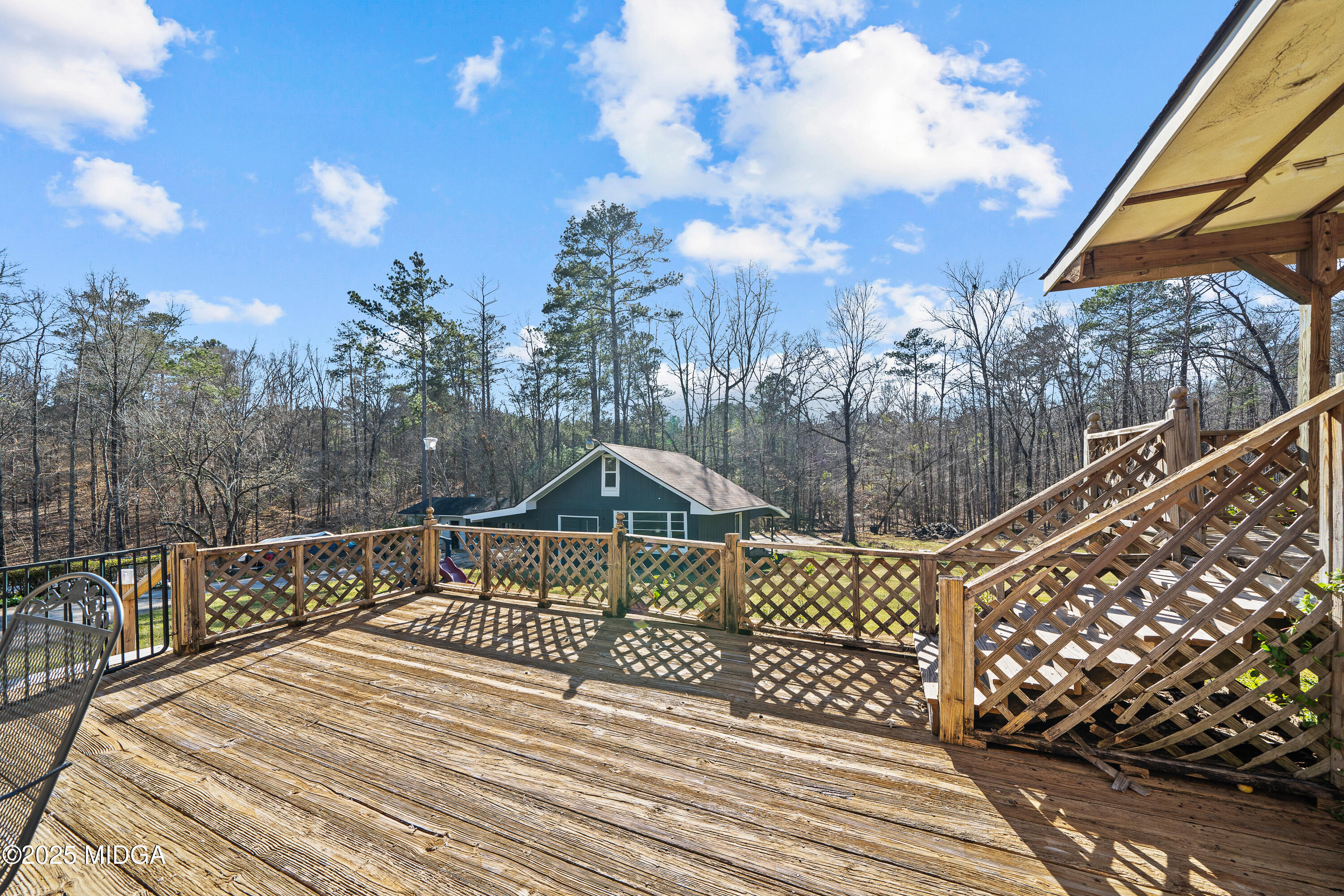 184 Camelot Road Gray, GA 31032 - Photo 36 of 38 a view of a wooden deck with sunset