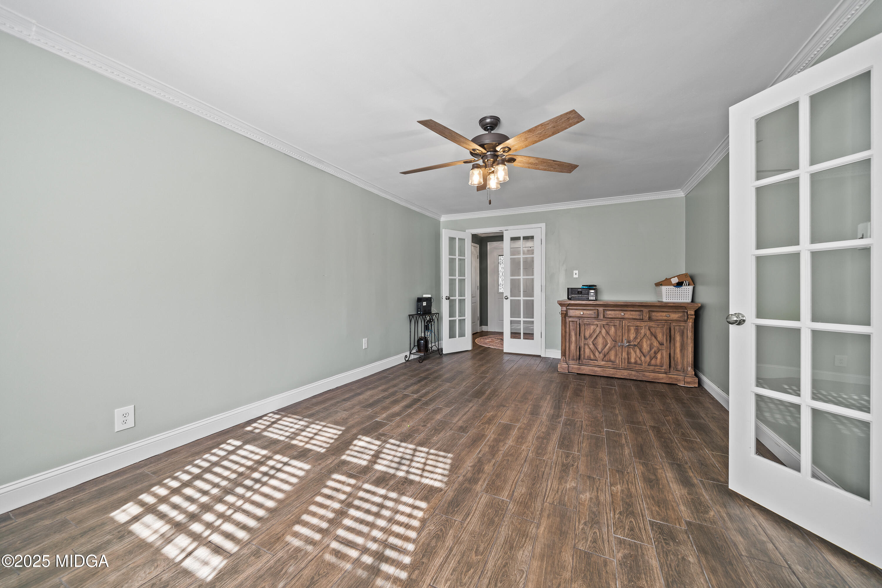 184 Camelot Road Gray, GA 31032 - Photo 7 of 38 a view of a big room with wooden floor and windows