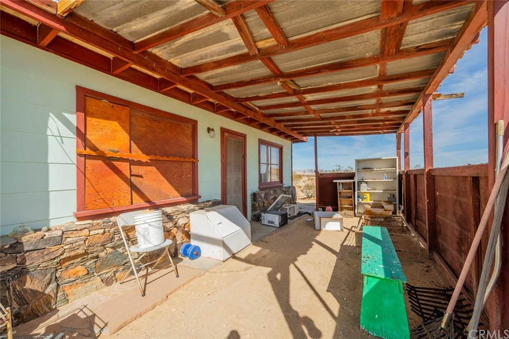 736 Copper Mountain Road Joshua Tree, CA 92252 - Photo 12 of 28 a bed room with a bed next to a window