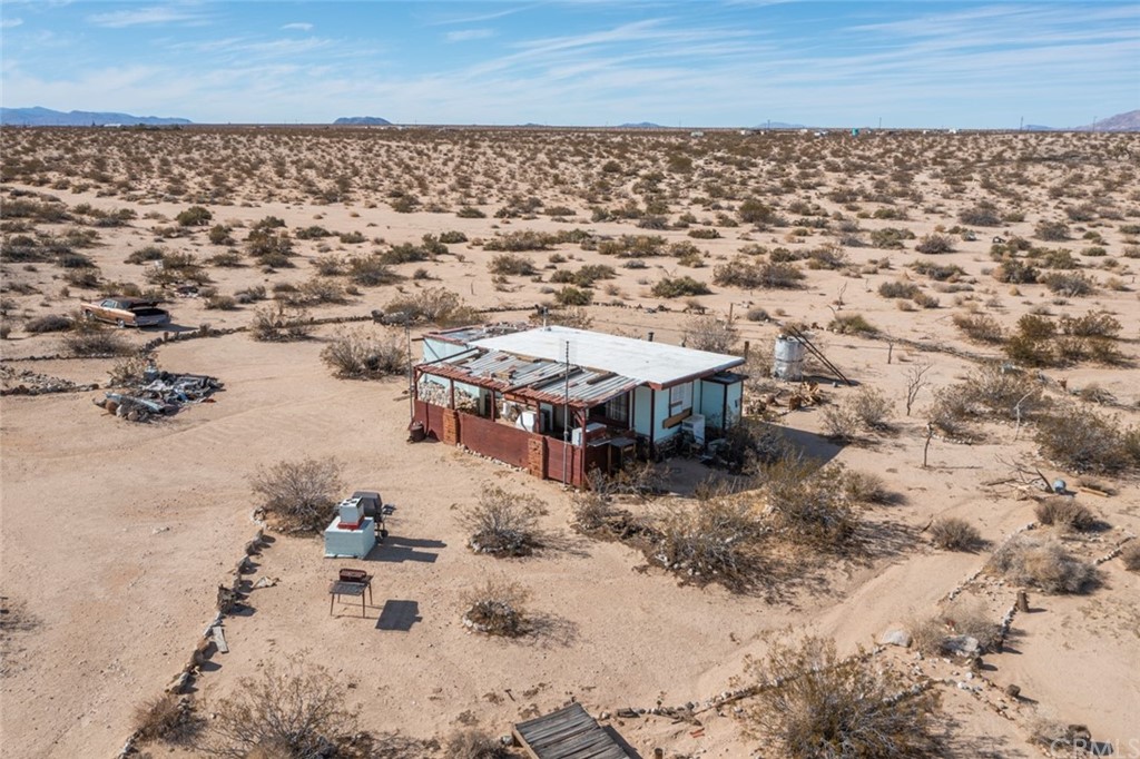 736 Copper Mountain Road Joshua Tree, CA 92252 - Photo 17 of 28 an aerial view of a house with a yard