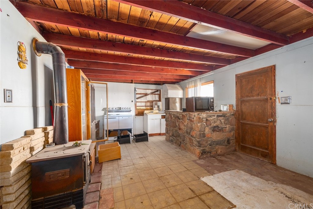 736 Copper Mountain Road Joshua Tree, CA 92252 - Photo 6 of 28 a bed room with a bed and a view of living room
