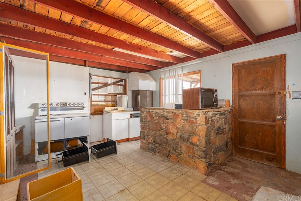 736 Copper Mountain Road Joshua Tree, CA 92252 - Photo 8 of 28 a view of kitchen with furniture and refrigerator