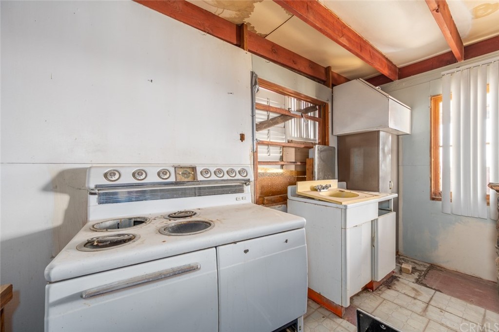 736 Copper Mountain Road Joshua Tree, CA 92252 - Photo 9 of 28 a kitchen with a stove and a refrigerator