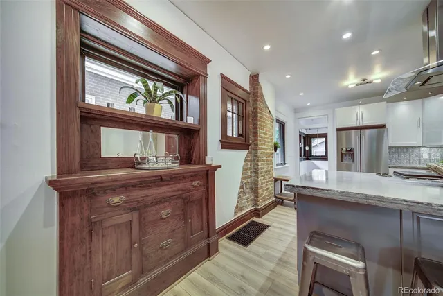 a kitchen with stainless steel appliances granite countertop wooden cabinets a stove and a sink