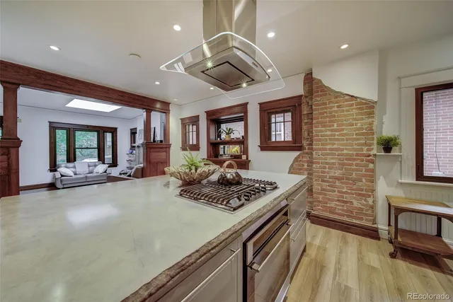 a kitchen with stainless steel appliances granite countertop a stove and a refrigerator