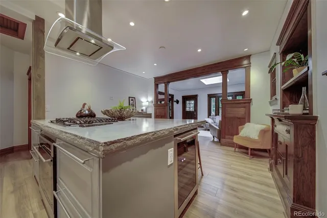 a kitchen with stainless steel appliances granite countertop a sink counter space and wooden floor
