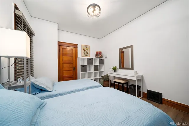 a bedroom with a bed and a desk