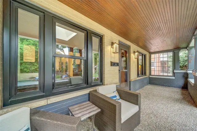 a living room with furniture and a floor to ceiling window